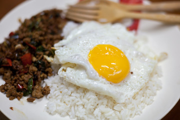 Rice topped with stir-fried pork and basil with Fried egg