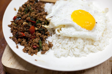 Rice topped with stir-fried pork and basil with Fried egg