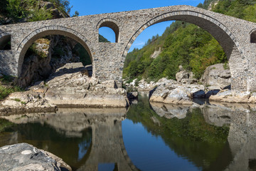 Fototapeta na wymiar Amazing Reflection of Devil's Bridge in Arda river, Kardzhali Region, Bulgaria