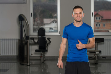 Fototapeta na wymiar Personal Trainer Showing Thumbs Up Sign