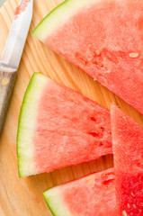 Slices of watermelon on a wood cutting board