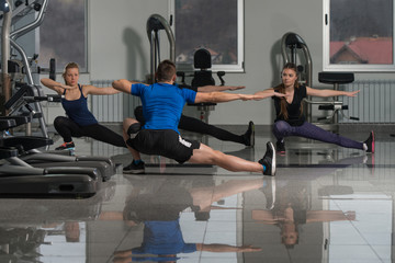 People Stretching During Fitness Class In Fitness Center
