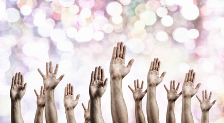 Group of people with raised hands