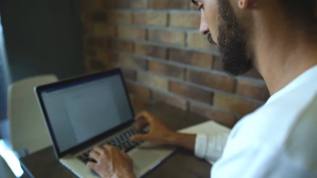 intelligent male freelancer work on notebook