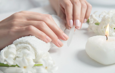 Woman getting nail manicure.