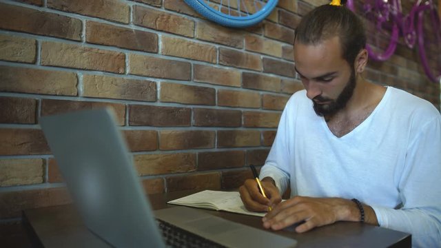 intelligent male freelancer work on notebook