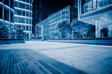 Fototapeta na wymiar night view of empty brick floor front of modern building