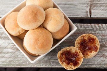 Fresh homemade whole wheat dinner rolls top view with pluot jam
