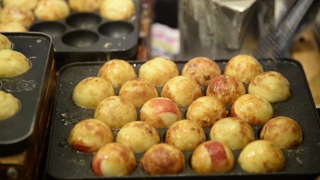 Unknown people cooking Japanese Meat Balls call Takoyaki closeup
