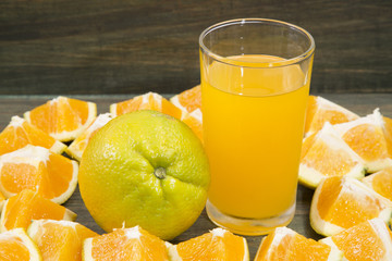 Slices of orange and glass of juice.