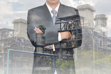 Double exposure of business man arms folded and and Electric Generating Factory, Power Reactor as vision of leader and Energy concept.