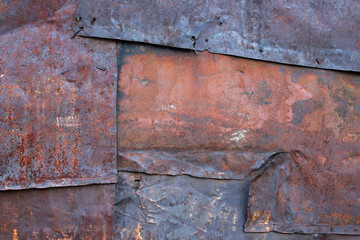 old rusty metal sheets nailed overlapping. background