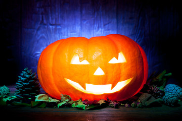 Scary Halloween pumpkin on a blue wooden background