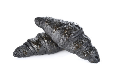 Charcoal croissant on white background