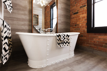 Close up of white freestanding bath tub