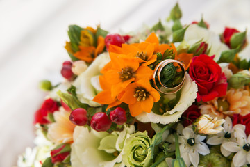 Wedding or engagement ring on banch of  flowers.