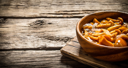 Marinated mushrooms in a bowl on the Board.