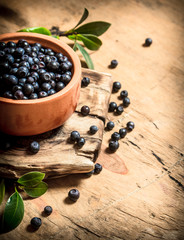 Fresh blueberries in a Cup. On wooden table.