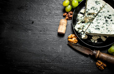 piece of blue cheese, walnuts and white grapes.
