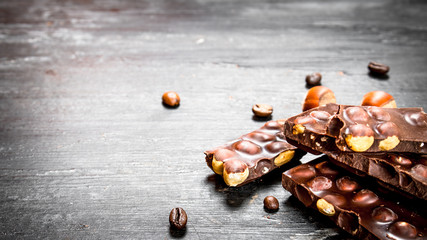 The chunks of chocolate with whole hazelnuts .