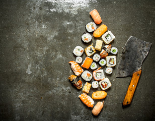Various Japanese sushi rolls with an axe for cutting. © Artem Shadrin