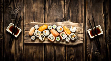 Muurstickers Sushi and rolls seafood with soy sauce. © Artem Shadrin