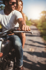 Naklejka premium Man riding on a motorcycle with girlfriend