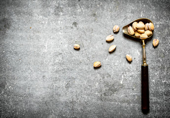 Pistachios in an old spoon.