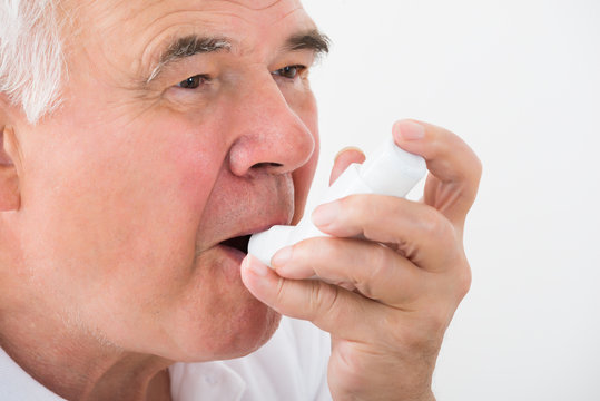 Man Using Asthma Inhaler