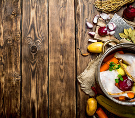 Ingredients for cooking chicken soup with vegetables and spices.