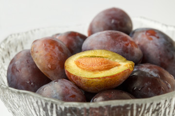 Red plums in a glass bowl