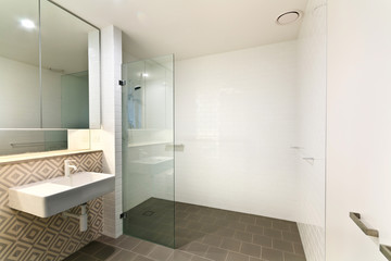 Stylish clean bathroom with shower and bath tub