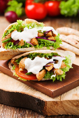 Pita salad with roasted chicken and vegetables, served with a de