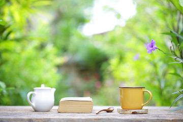 white vintage  teapot  with yellow mug and notebook