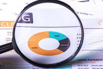 Magnifying glass and business growth graph