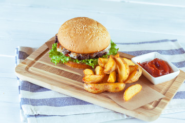 burger and french fries on wooden table