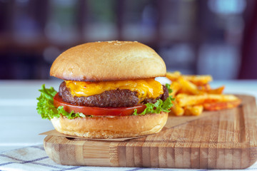 burger and french fries on wooden table