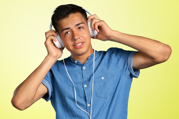 portrait of a young man listening to music with headphones