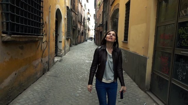 Young woman walking through old town in Rome, Italy, super slow motion 240fps
