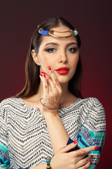 beautiful woman in oriental style with mehendi on dark background