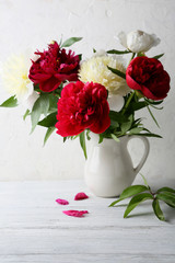 fresh peonies in white vase