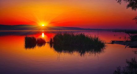 Beautiful sunset over calm lake. Dusk time