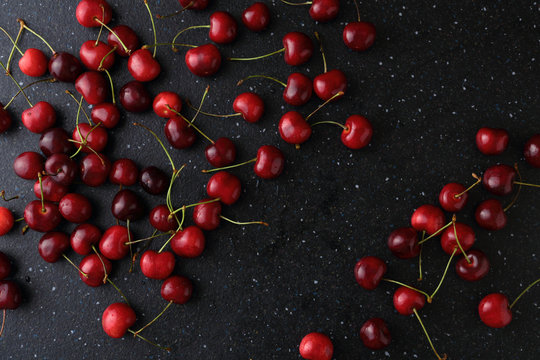 Dark food background with cherries.