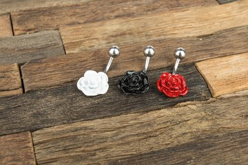 Jewelry for piercing on wooden background. Stock Image macro.