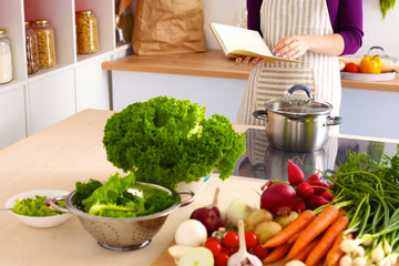 Cook's hands preparing vegetable salad - closeup shot
