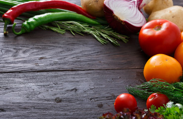 Frame of fresh vegetables on wooden background with copy space