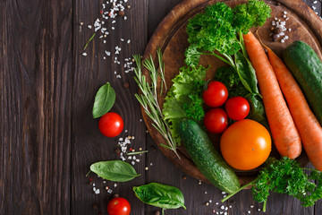 Plenty of fresh vegetables on wooden background with copy space