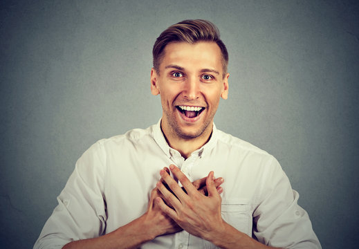 man looking shocked surprised laughing hands on chest