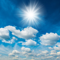 Naklejka na ściany i meble Bright shining sun with white clouds