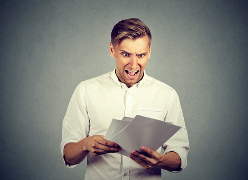 Angry businessman with documents